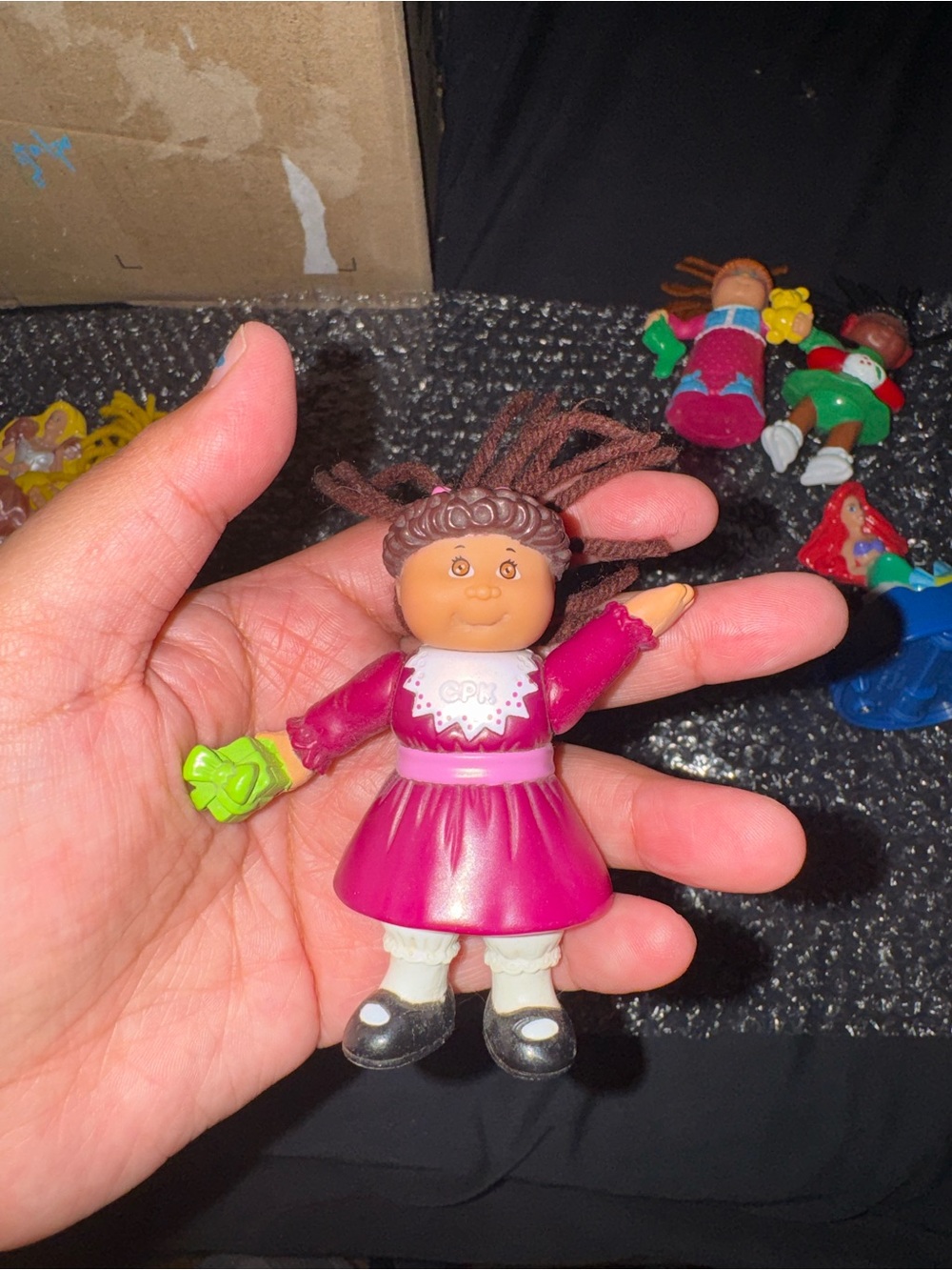 Small Pink Doll Figure with Green Accessory
